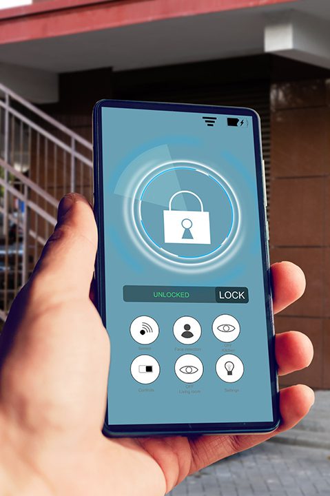 Female hand holding phone with smart home application for access to all of the controls