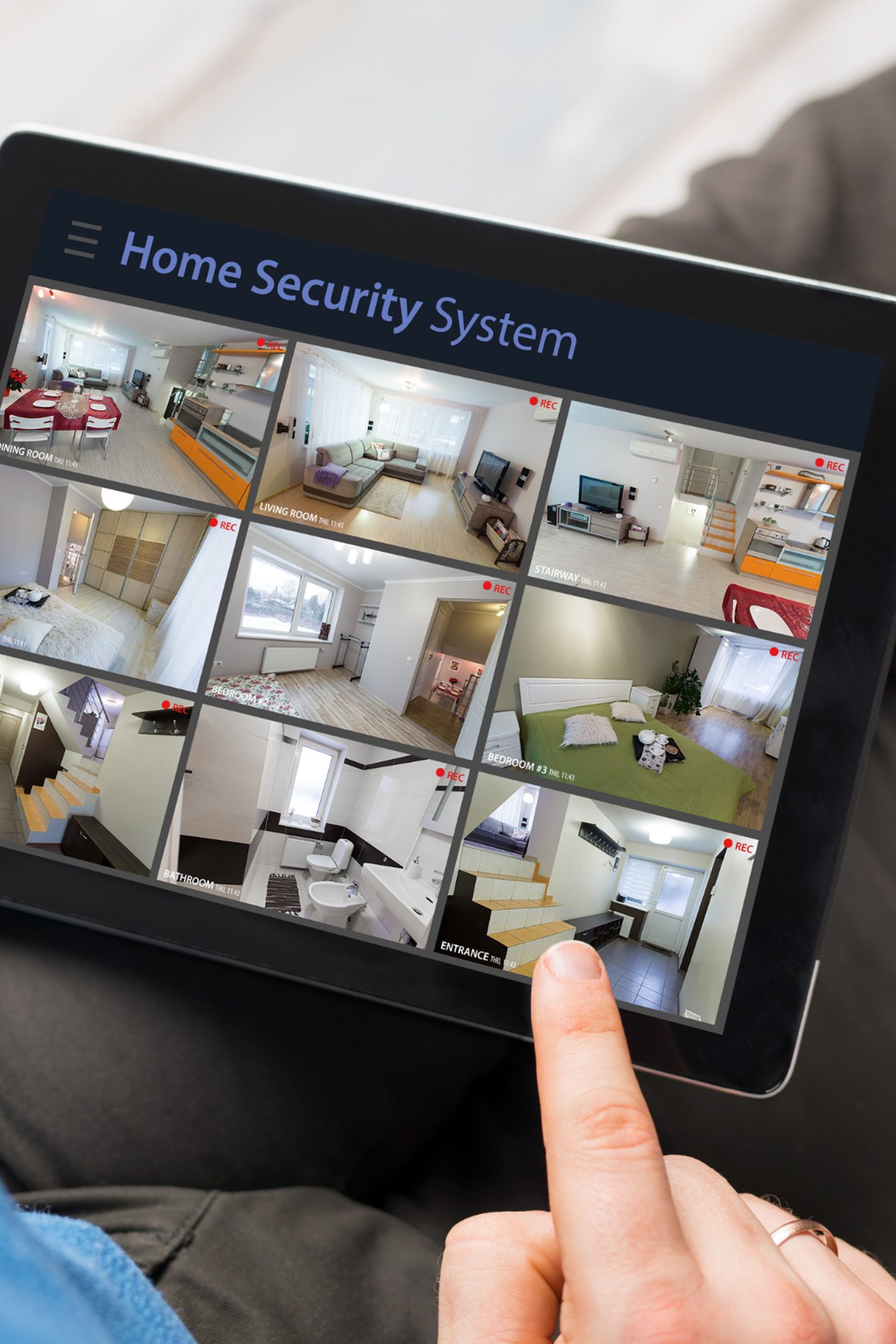 Man looking at home security cameras on tablet